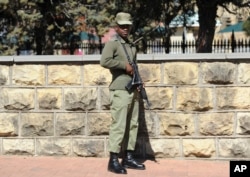 FILE - A soldier stands outside the military headquarters in Maseru, Lesotho, Aug. 31, 2014. Prime Minister Thomas Thabane said there had been an attempt to take over Lesotho, a country of about 2 million people that is surrounded by South Africa.