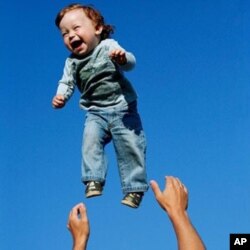 Andrei Balta throws his 15-month-old son Vanya in the air during a summer evening in Slavutych, Ukraine. Andrei and his wife Anna both work at the nearby Chernobyl Nuclear Power Plant, as do over 3,800 residents of Slavutych.