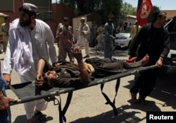 A man is carried to a hospital on a strecher after a car bomb attack in Lashkar Gah, Helmand province, Afghanistan, June 22, 2017.