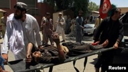 A man is carried to a hospital on a strecher after a car bomb attack in Lashkar Gah, Helmand province, Afghanistan, June 22, 2017.
