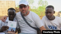 Gabriel Stauring, pictured here with two refugees, Rahma and Murtada, has been coordinating the Darfur United effort. (Photo courtesy i-Act charity)