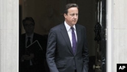 Britain's Prime Minister David Cameron leaves Downing Street in London, to attend Parliament, August 11, 2011