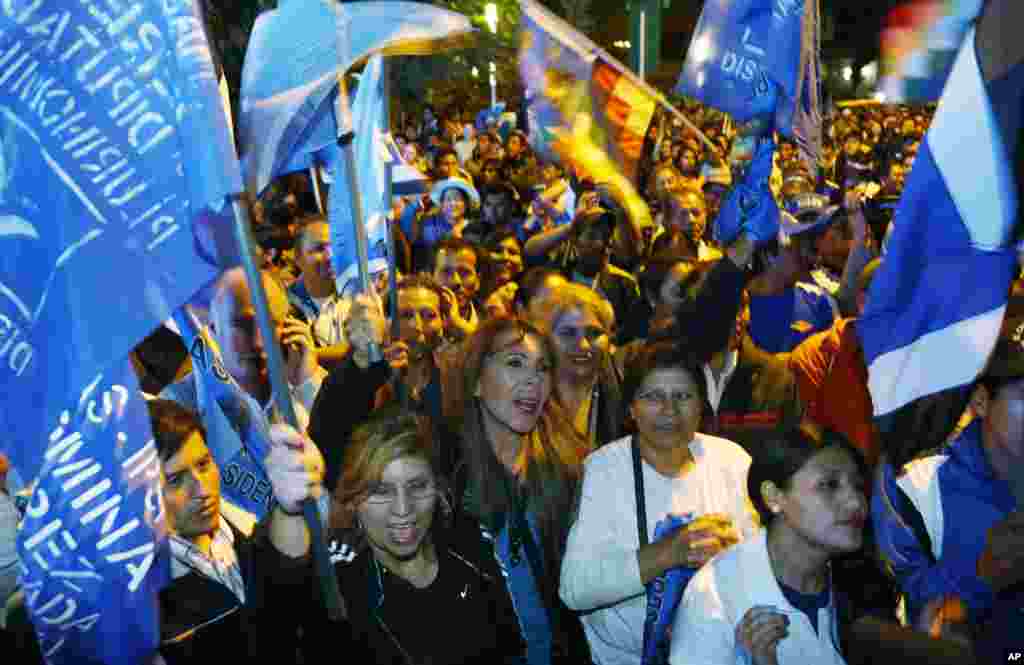 Supporters of Bolivia's President Evo Morales celebrate after partial results of the elections were released in Cochabamba, Oct. 12, 2014.