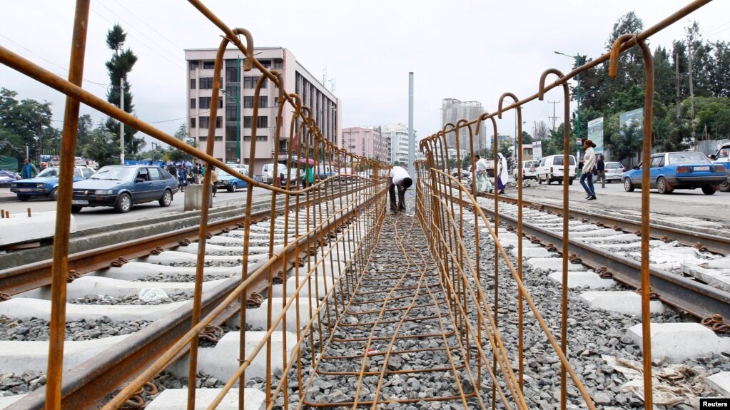 FILE - A laborer works at a light railway transit system under construction in Ethiopia's capital, Addis Ababa, June 25, 2014. Profitability concerns have slowed funding from China for some rail projects.
