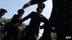 FILE - Newly-graduated female Afghan National Army (ANA) officers march during a graduation ceremony at the Afghan National Army training center in Kabul, Aug. 24, 2014. 