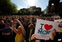 Crowds gather for a vigil in Albert Square, Manchester, England, May 23, 2017, the day after the suicide attack at an Ariana Grande concert that left 22 people dead as it ended on Monday night.