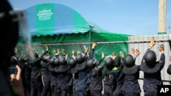 FILE - Police remove a fence to facilitate traffic flow near Wat Phra Dhammakaya temple in Pathum Thani province, north of Bangkok, Thailand, Tuesday, Dec. 27, 2016.