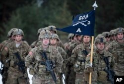 FILE - Troops from the U.S. Army take part in a NATO military exercise at a training range in Pabrade, north of the capital Vilnius, Lithuania, Dec. 2, 2016.