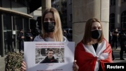 A woman displays a sign during a protest against the detention of Belarusian blogger, Roman Protasevich, who was detained as a Ryanair plane that he was on, en route from Athens to Vilnius, was forced to land in Minsk on Sunday, in Warsaw, Poland, May 24,