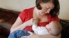 FILE - Jessica Ewald breast-feeds her 5-month-old son, Bennett, at her home in Oakbrook Terrace, Ill., Sept. 14, 2011.