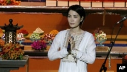 FILE - Chinese pop singer Faye Wong, also known as Wang Fei, performs at the third World Buddhist Forum in Hong Kong. China’s state media have criticized celebrities for attending an event with members of the Tibetan government-in-exile.