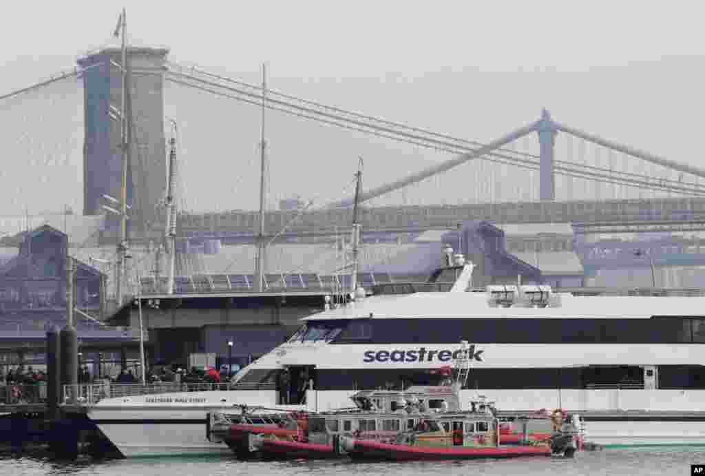 The Seastreak Wall Street ferry is docked near the Brooklyn Bridge, left, and Manhattan Bridge, right, following an accident, January 9, 2013.