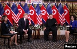 North Korean leader Kim Jong Un gestures as he and U.S. President Donald Trump sit down before their one-on-one chat during the second U.S.-North Korea summit at the Metropole Hotel in Hanoi, Vietnam, Feb. 27, 2019.