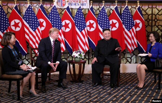 North Korean leader Kim Jong Un gestures as he and U.S. President Donald Trump sit down before their one-on-one chat during the second U.S.-North Korea summit at the Metropole Hotel in Hanoi, Vietnam, Feb. 27, 2019.