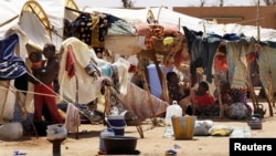 Malians displaced by war gather at a makeshift camp in Sevare, about 600 kms (400 miles) northeast of the capital Bamako, July 11, 2012.