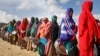 Women who fled drought queue to receive food distributed by local volunteers at a camp for displaced persons in the Daynile neighborhood on the outskirts of Mogadishu, in Somalia, May 18, 2019. 
