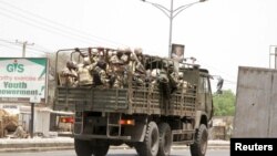 FILE - Soldiers are seen on a truck along a road in Maiduguri in Borno State, Nigeria.