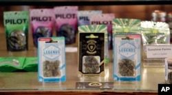 Marijuana products fill a display cabinet in the Herban Legends pot shop, Jan. 4, 2018, in Seattle.