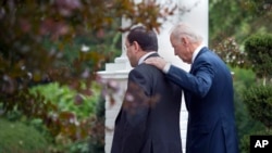 Vice President Joe Biden walks with Iraq's Prime Minister Nouri al-Maliki into the vice president's residence, the Naval Observatory, for a breakfast meeting, Oct. 30, 2013, in Washington.