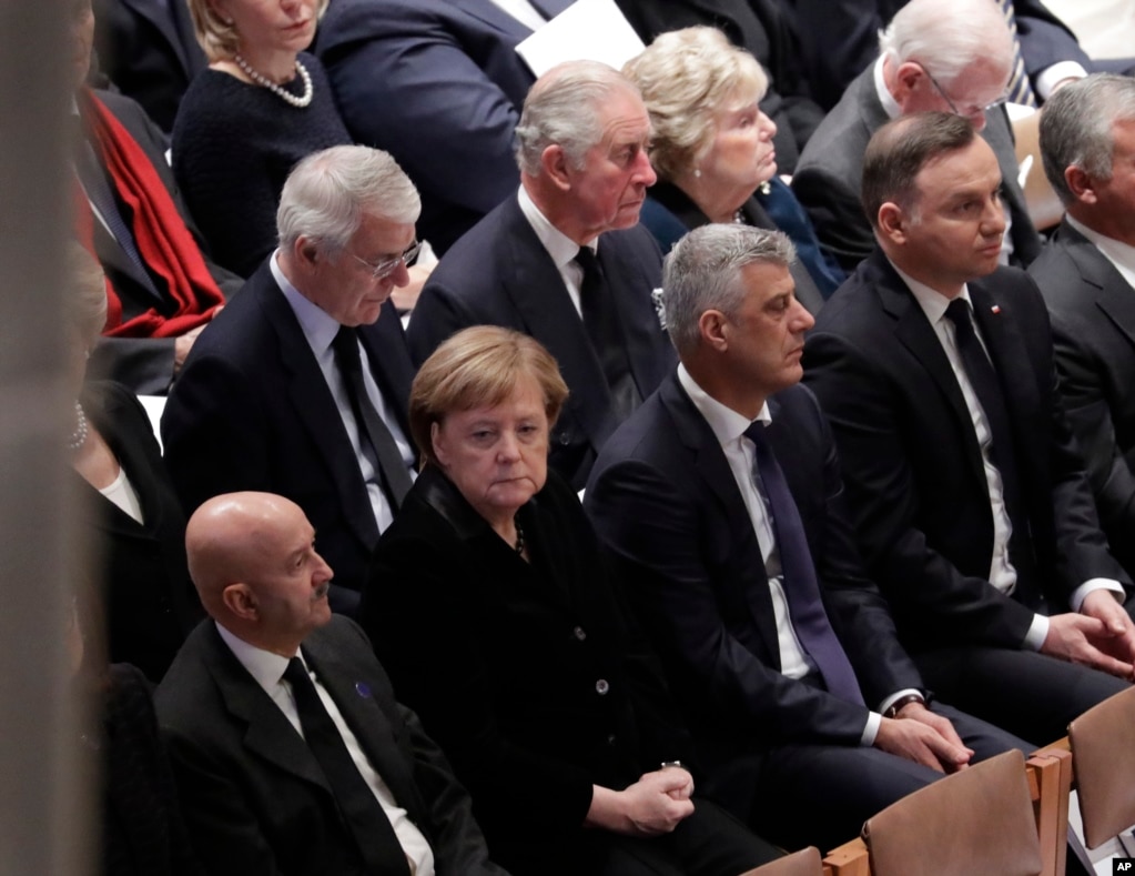 Britain's Prince Charles, second from left, back row, and German Chancellor Angela Merkel, second from left, bottom row, are shown seated during a State Funeral for former President George H.W. Bush at the National Cathedral, Dec. 5, 2018.