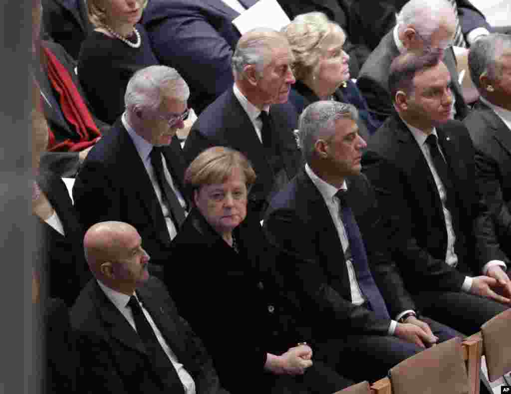 Britain&#39;s Prince Charles, second from left, back row, and German Chancellor Angela Merkel, second from left, bottom row, are shown seated during a State Funeral for former President George H.W. Bush at the National Cathedral, Dec. 5, 2018.