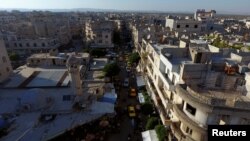 FILE - A general view taken with a drone shows part of the rebel-held Idlib city, Syria, June 8, 2017.