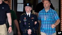 U.S. Army Pfc. Bradley Manning is escorted out of a courthouse in Fort Meade, Maryland, July 2, 2013, during the fifth week of his court-martial. 
