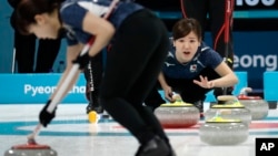Japan's Chinami Yoshida shouts instructions to teammates during their women's curling match against China at the 2018 Winter Olympics in Gangneung, South Korea, Feb. 17, 2018.
