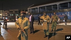 Policemen secure the scene of a deadly grenade explosion in Kenya's capital, Nairobi, October 24, 2011.