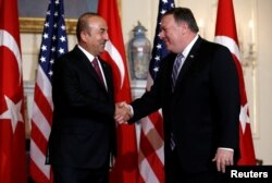 U.S. Secretary of State Mike Pompeo shakes hands with Turkish Foreign Minister Mevlut Cavusoglu at the State Department in Washington, June 4, 2018.