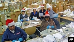 Some of the 22 postal "elves" who volunteer to organize letters to Santa and arrange for the public or charities to "adopt" them.