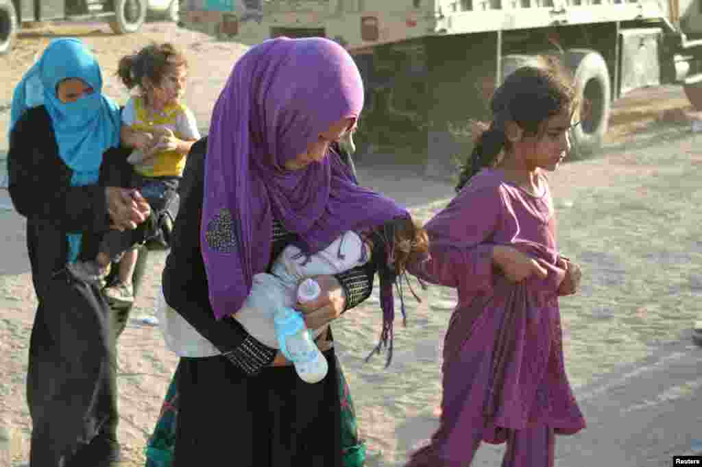 Displaced people, who fled Islamic State violence, are seen in Lake al-Tharthar, northwest of Baghdad, Iraq, July 10, 2016.