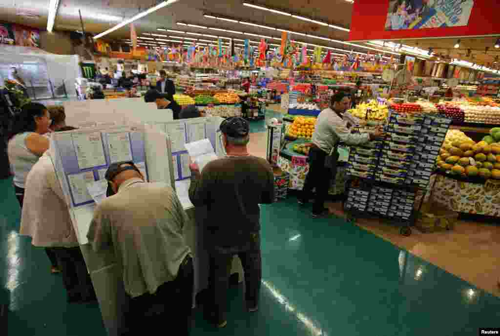 People cast their ballots at a neighborhood grocery store in National City, California.