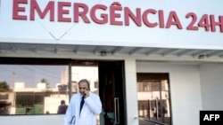 Brazilian infectologist Antonio Bandeira, who was part of the team of researchers who identified the Zika virus in Brazil, talks by mobile in front of the Santa Helena hospital in Camaçari, Bahia, Brazil on Jan. 29, 2016, Brazil. Brazilian President Dil