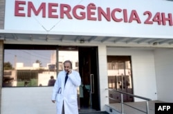Brazilian infectologist Antonio Bandeira, who was part of the team of researchers who identified the Zika virus in Brazil, talks by mobile in front of the Santa Helena hospital in Camaçari, Bahia, Brazil on Jan. 29, 2016.