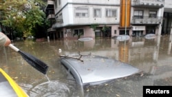Submerged cars in a flooded street after a rainstorm in La Plata, Argentina, April 2, 2013. 