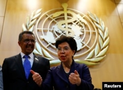 FILE - Outgoing Director-General Margaret Chan, right, poses with Tedros Adhanom Ghebreyesus after his election as Director General of the World Health Organization (WHO) during the 70th World Health Assembly in Geneva, Switzerland, May 23, 2017.