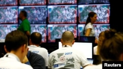 Estonia -- People walk past screens during the Locked Shields 2017 exercise organized by NATO Cooperative Cyber Defense Center of Excellence in Tallinn, April 26, 2017