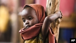 A newly arrived Somali refugee child awaits medical examinations at the Dadaab refugee camp, near the Kenya-Somalia border, July 23, 2011