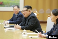 FILE - North Korean leader Kim Jong Un meets members of the special delegation of South Korea's President in this photo released by North Korea's Korean Central News Agency (KCNA) on March 6, 2018.