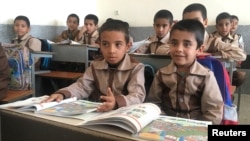 FILE - Boys study in a classroom at a school in Kerman, Iran, Oct. 23, 2016.