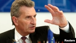 European Energy Commissioner Guenther Oettinger addresses a news conference in Vienna, June 16, 2014. 