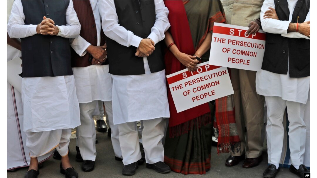 Indian lawmakers from opposition parties hold placards in the parliament premises during a protest against the government demonetizing high-value bills in New Delhi, India, Wednesday, Nov. 23, 2016.