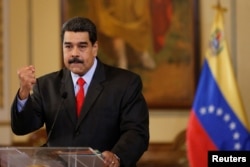 Venezuela's President Nicolas Maduro gestures as he talks to the media during a news conference in Caracas, Venezuela, Feb. 15, 2018.