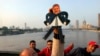 Standing on the Qasr El-Nile Bridge in Cairo during a February 10 anti-Muslim Brotherhood protest, artist Mohammed Darwish displays a puppet he designed of Egypt’s former president, Mohammed Morsi.