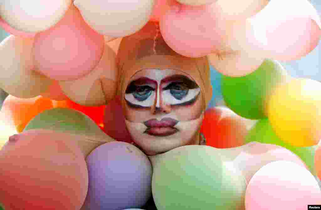 A reveler poses during the Street Parade dance music event in Zurich, Switzerland, Aug. 10, 2019.