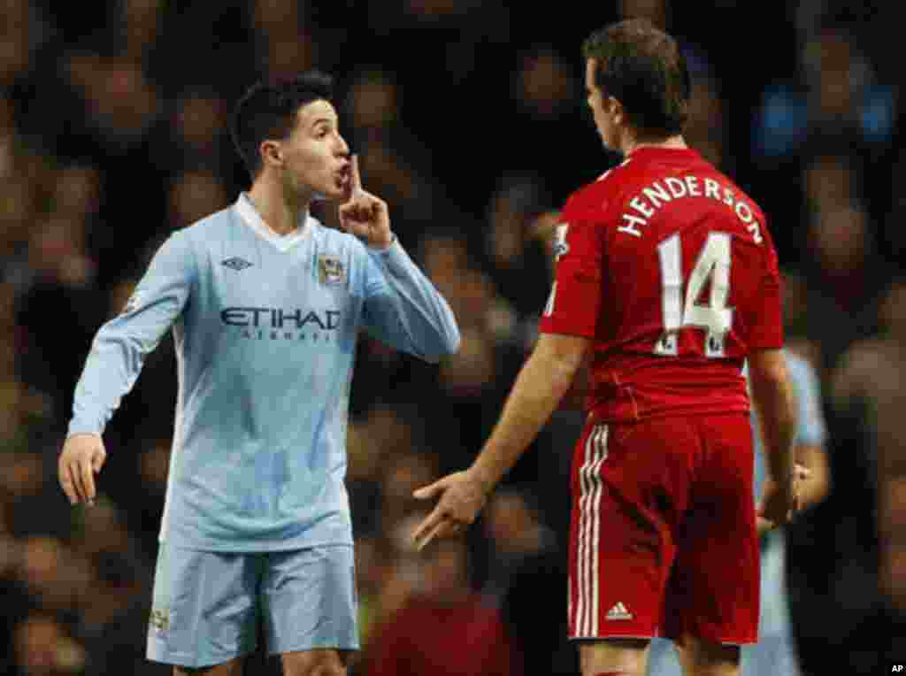 Manchester City's Samir Nasri (L) gestures to Liverpool's Jordan Henderson during their English League Cup semi-final, first leg soccer match at the Etihad Stadium in Manchester, northern England, January 11, 2012.