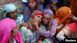 Relatives of Andleeb Jan, 16, who according to local media died during clashes between protesters and Indian security forces, mourn during her funeral in South Kashmir's Kulgam district, July 7, 2018. 