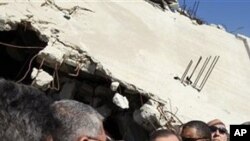 UN Secretary General Ban Ki-moon, centre, visits a destroyed house in Jebaliya, northern Gaza Strip, Sunday, March 21, 2010. U.N. chief Ban Ki-moon has entered the blockaded Gaza Strip, where 1.5 million people have been under lockdown by Israel and Egypt
