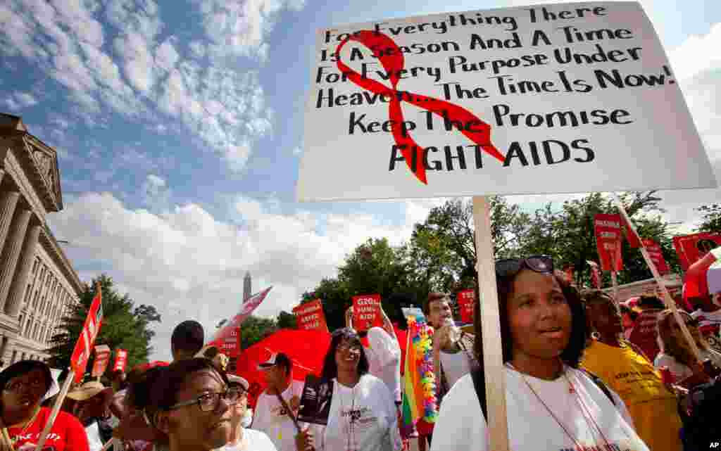 People walk in the AIDS March in Washington, July 22, 2012.